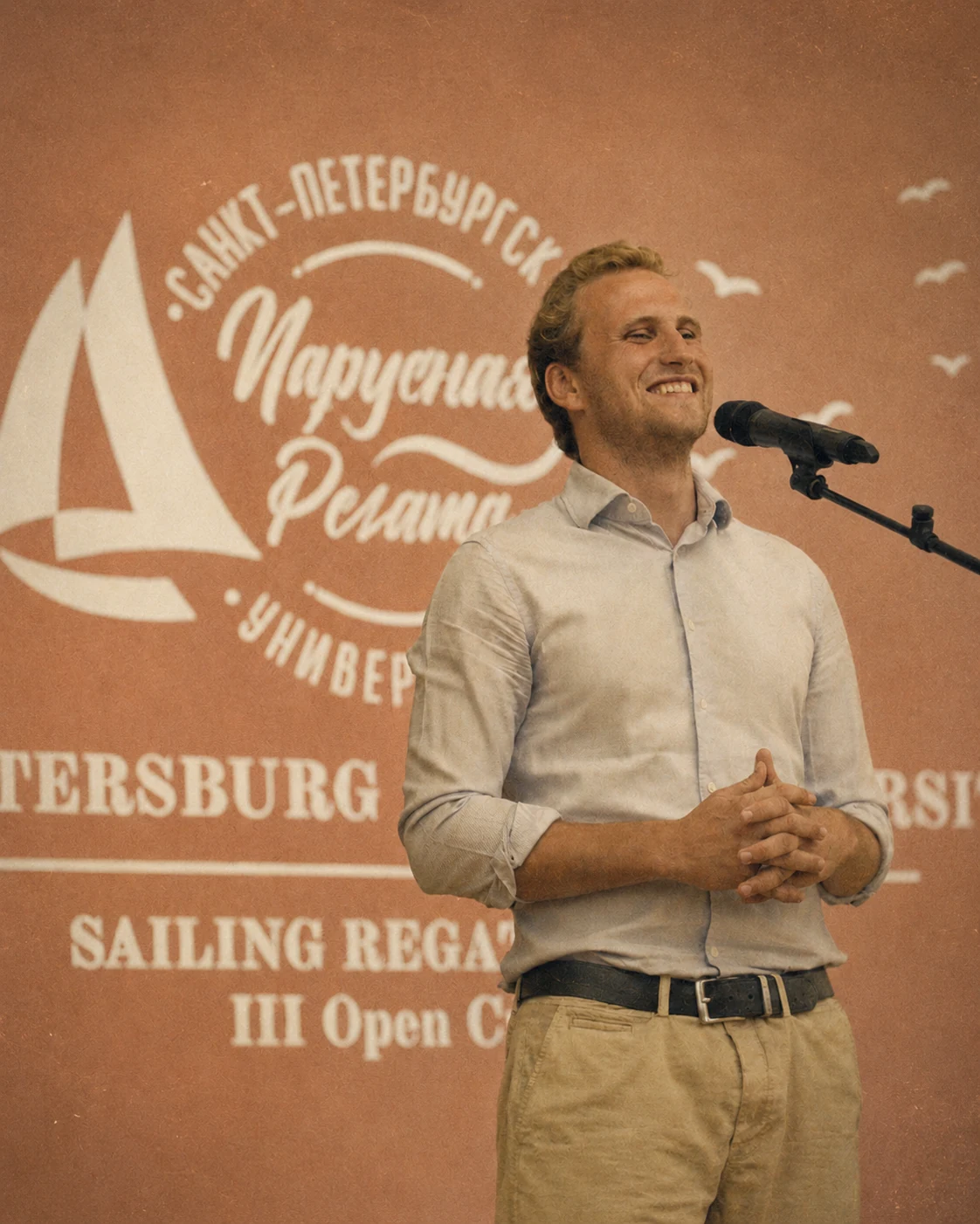 Denis Kotlyarov speaking at a regatta event.